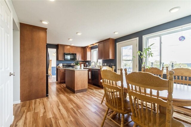 dining area with light wood-style floors, plenty of natural light, recessed lighting, and baseboards