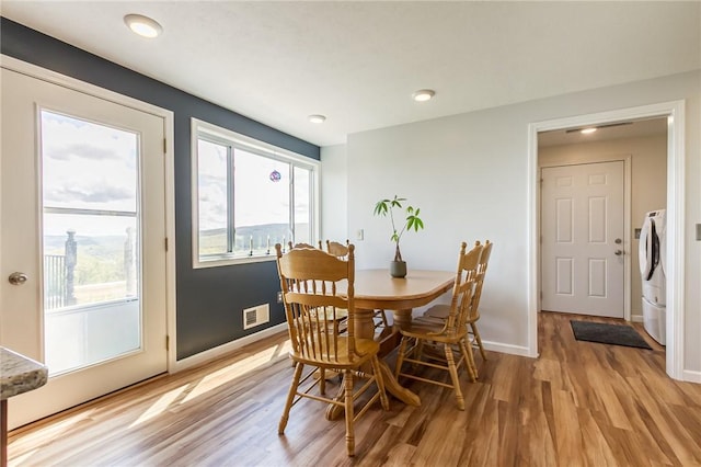 dining area with light wood-style flooring, baseboards, washer / dryer, and recessed lighting