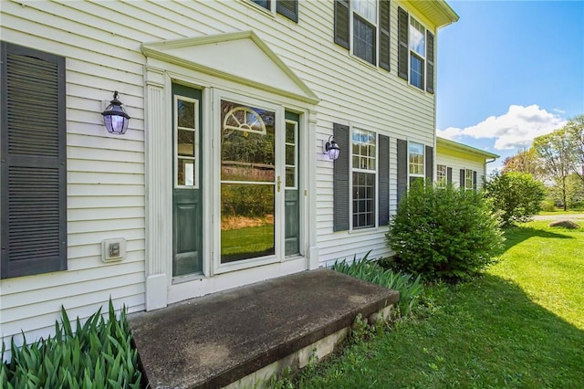 view of side of home with a lawn