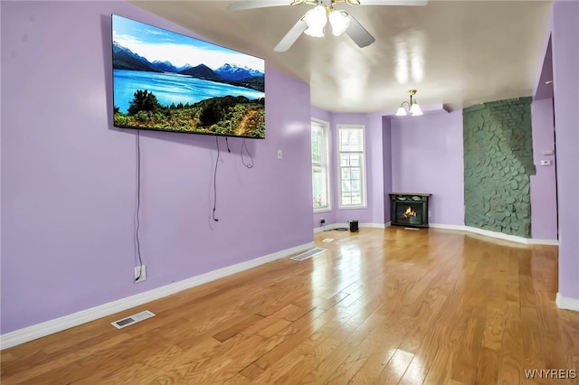 165 Breckenridge St, Buffalo, NY 14213 - unfurnished living room with light wood finished floors, ceiling fan, a fireplace, baseboards, and a chandelier