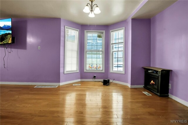 165 Breckenridge St, Buffalo, NY 14213 - unfurnished dining area with a chandelier, wood finished floors, and baseboards
