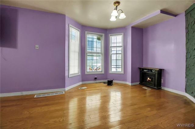 165 Breckenridge St, Buffalo, NY 14213 - unfurnished dining area featuring hardwood / wood-style flooring, baseboards, and a warm lit fireplace