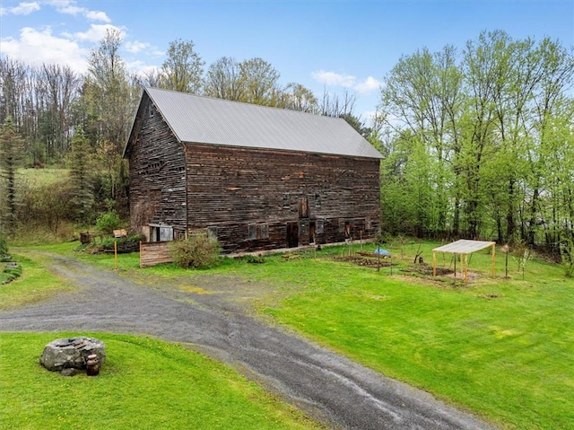 7471 State Highway 80, Springfield, NY 13326 - view of property exterior with an outdoor structure, a yard, and metal roof