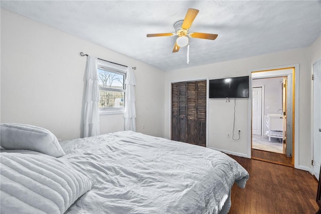 bedroom with wood finished floors, a closet, ceiling fan, and baseboards