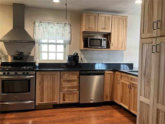 1940 State Highway 41, Coventry, NY 13733 - kitchen with stainless steel appliances, wall chimney range hood, dark countertops, dark wood-type flooring, and recessed lighting