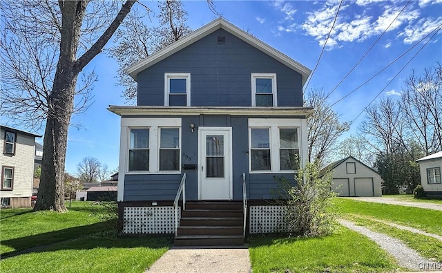 view of front of home featuring a garage, dirt driveway, a front lawn, and an outbuilding