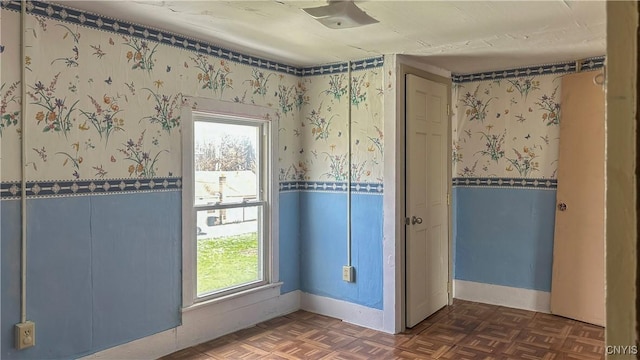 unfurnished room with plenty of natural light and baseboards