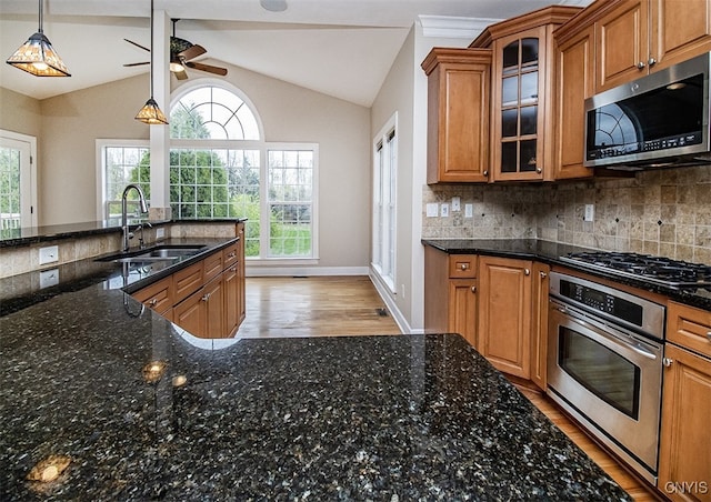 100 Brandywine Dr, Manlius, NY 13104 - kitchen featuring stainless steel appliances, a sink, brown cabinetry, light wood-type flooring, and ceiling fan