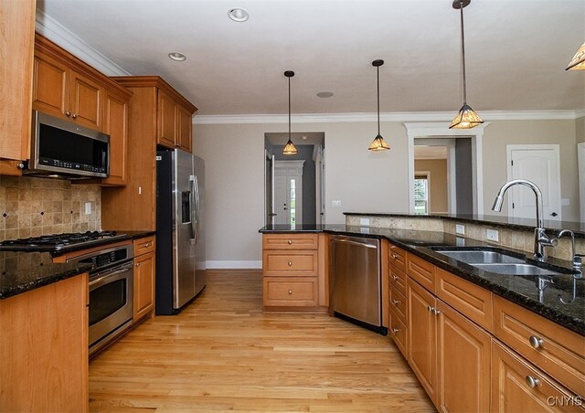 100 Brandywine Dr, Manlius, NY 13104 - kitchen with appliances with stainless steel finishes, a sink, brown cabinetry, crown molding, and decorative backsplash