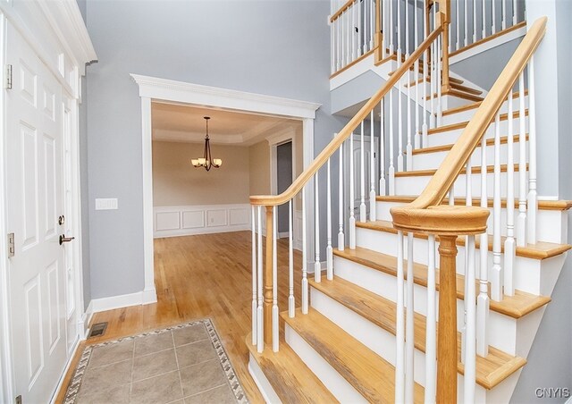 100 Brandywine Dr, Manlius, NY 13104 - staircase with wood finished floors, a chandelier, and ornamental molding