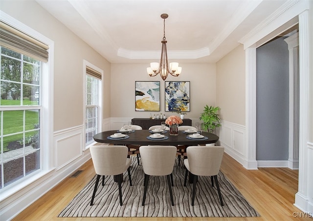 100 Brandywine Dr, Manlius, NY 13104 - dining space featuring light wood finished floors, a tray ceiling, a chandelier, wainscoting, and a decorative wall