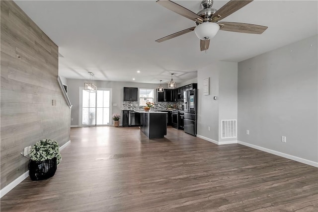 kitchen featuring open floor plan, smart refrigerator, baseboards, a center island, and recessed lighting