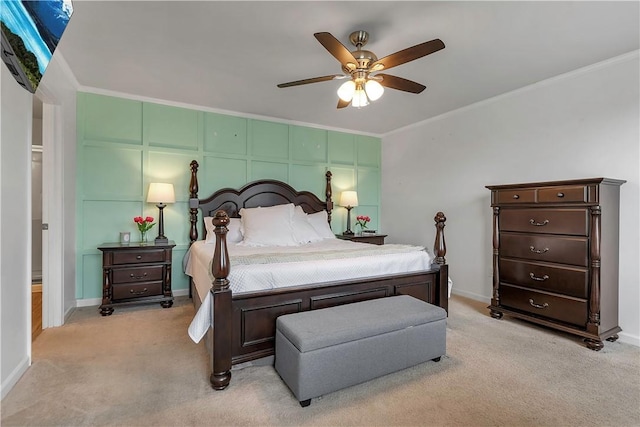 bedroom featuring light colored carpet, ornamental molding, baseboards, and a ceiling fan