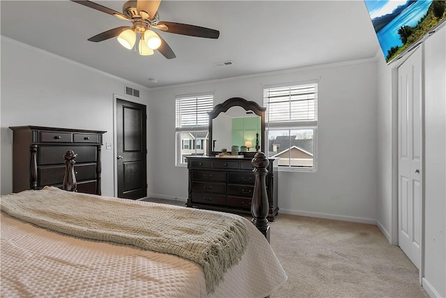 carpeted bedroom with ornamental molding, baseboards, and a ceiling fan