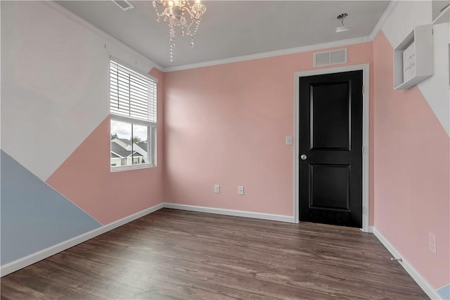 spare room featuring wood finished floors, a chandelier, baseboards, and ornamental molding