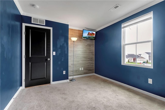 unfurnished room with crown molding, carpet flooring, baseboards, plenty of natural light, and a smoke detector