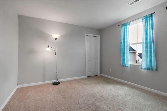 empty room with carpet floors and baseboards