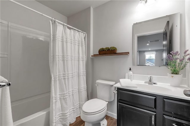full bathroom featuring wood finished floors, toilet, vanity, and shower / tub combo with curtain