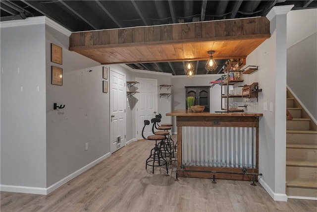 indoor bar with stairway, wood finished floors, and baseboards