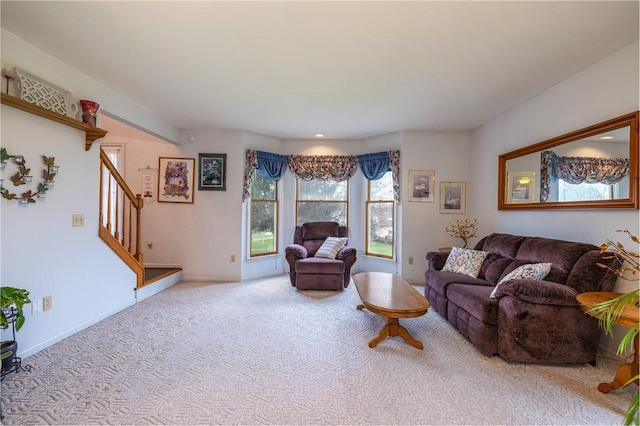 8 Hawkes Trl, Penfield, NY 14580 - living room featuring stairway, carpet flooring, and baseboards