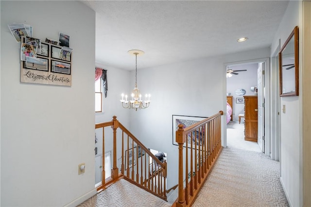 8 Hawkes Trl, Penfield, NY 14580 - hallway with an upstairs landing, a chandelier, carpet flooring, and recessed lighting