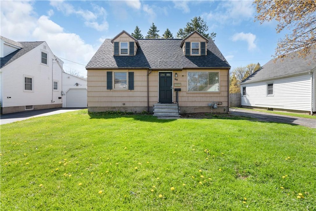 69 Ridgewood Rd, Greece, NY 14626 - view of front of house with a shingled roof, a front yard, a garage, and an outdoor structure