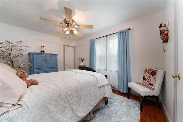 bedroom featuring wood finished floors, ceiling fan, and baseboards