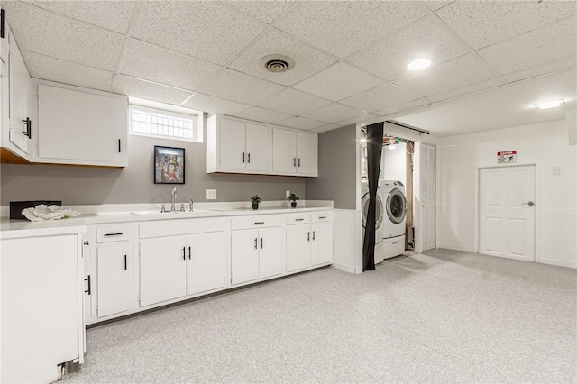 clothes washing area with independent washer and dryer and light colored carpet