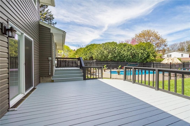 wooden terrace featuring a fenced backyard