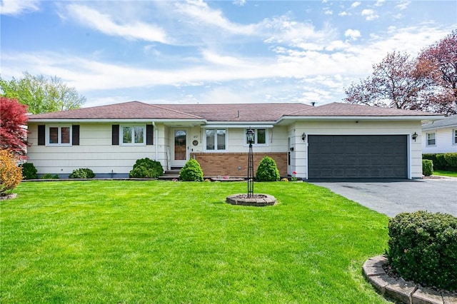 ranch-style house featuring driveway, an attached garage, and a front lawn