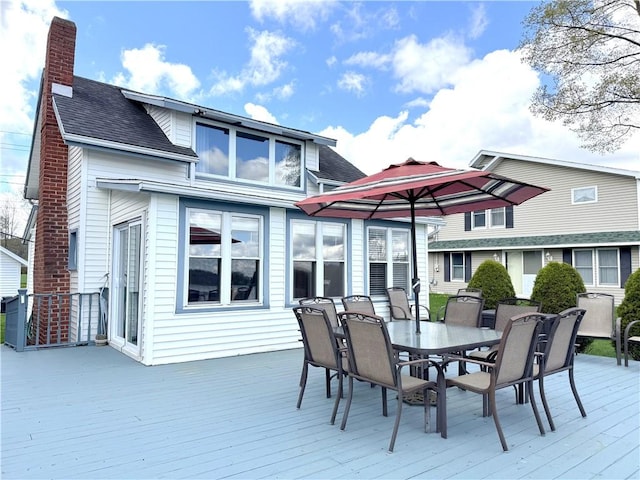 wooden terrace with outdoor dining area