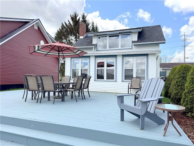wooden terrace with outdoor dining area