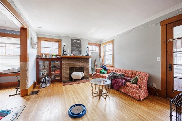45 Juniper St, Rochester, NY 14610 - living room featuring wood finished floors, ornamental molding, a fireplace, and baseboards