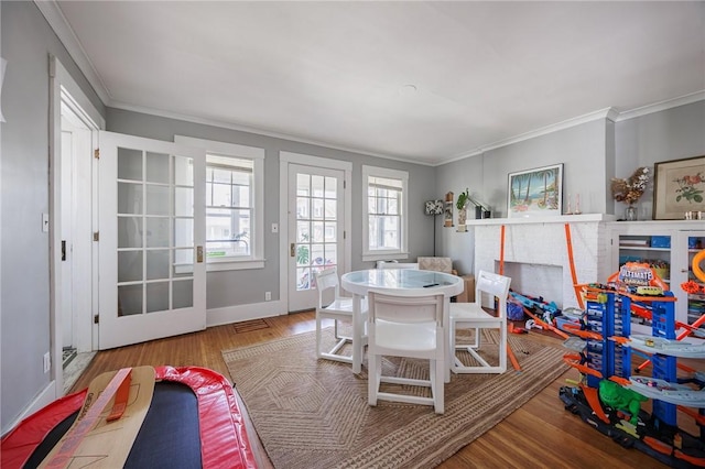 45 Juniper St, Rochester, NY 14610 - playroom featuring ornamental molding, wood finished floors, and baseboards
