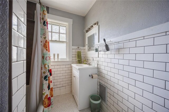45 Juniper St, Rochester, NY 14610 - full bathroom featuring tile walls, vanity, tile patterned floors, a shower with shower curtain, and a wainscoted wall