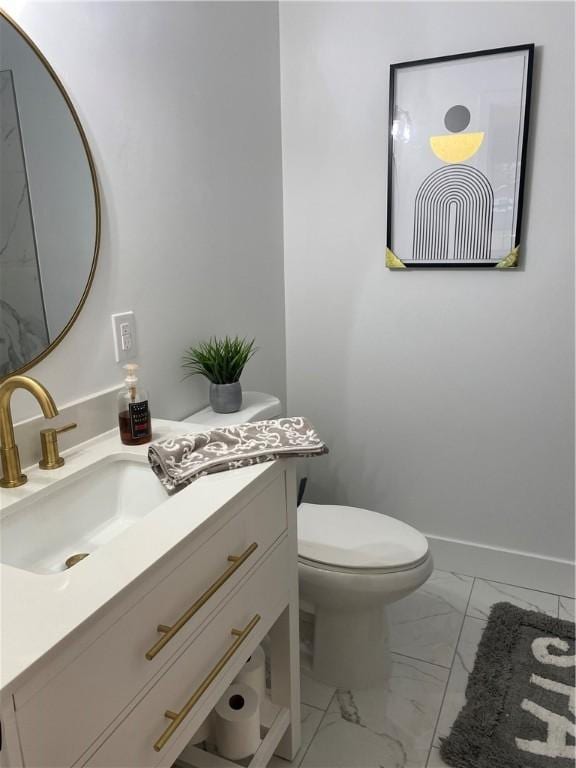 half bathroom featuring marble finish floors, vanity, toilet, and baseboards