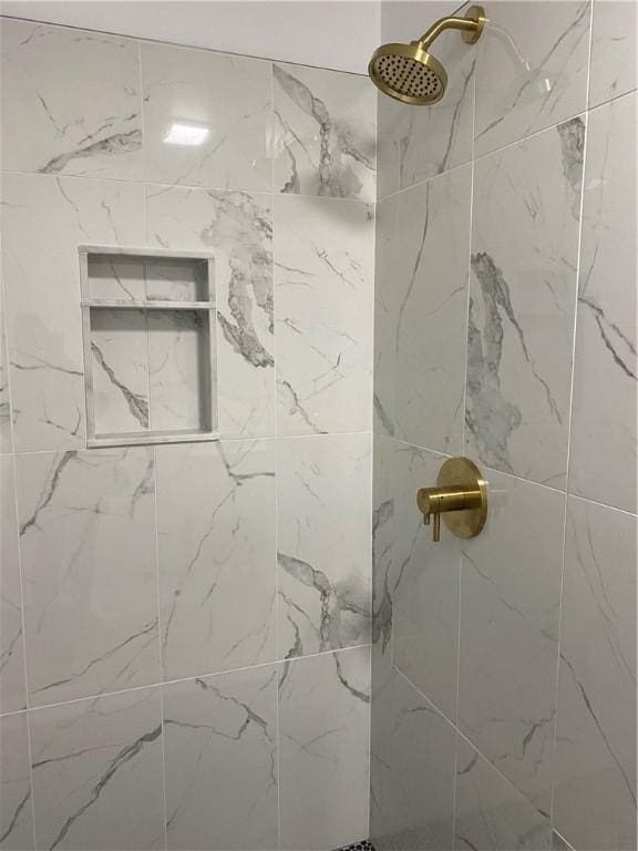 full bathroom with tiled shower