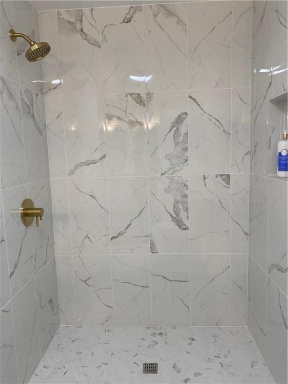 full bathroom with a tile shower