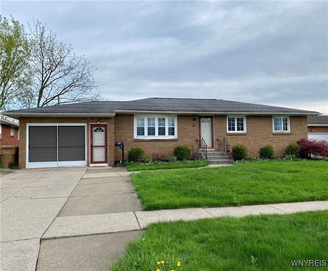 single story home featuring concrete driveway, an attached garage, brick siding, a front yard, and entry steps