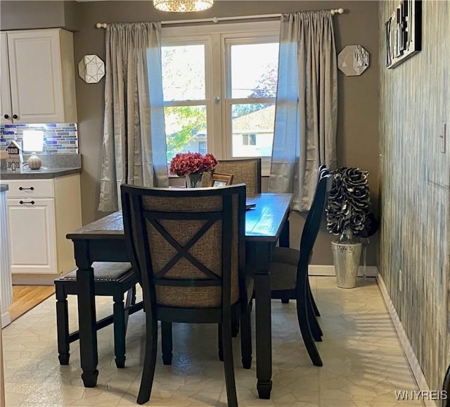 dining space featuring baseboards