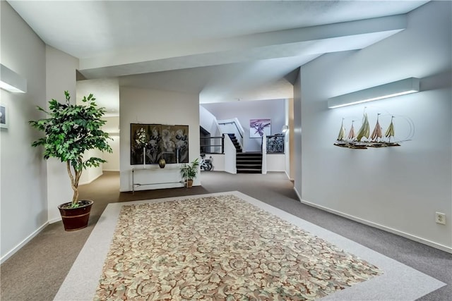 hallway featuring carpet flooring, stairway, and baseboards