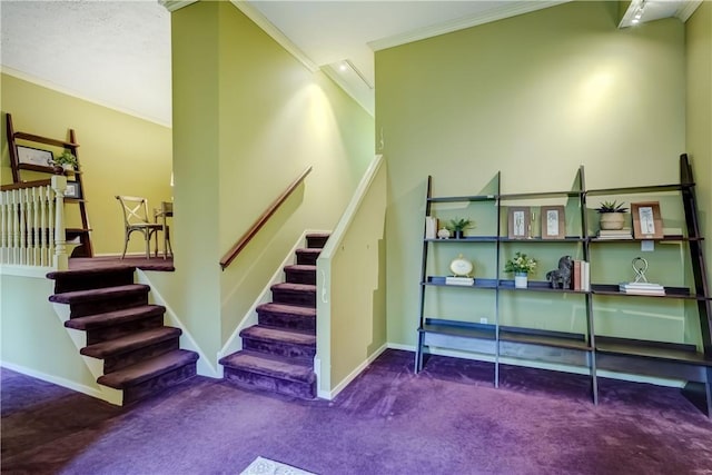 stairs with carpet floors, ornamental molding, and baseboards