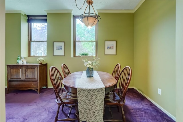 dining space featuring carpet flooring, baseboards, and crown molding