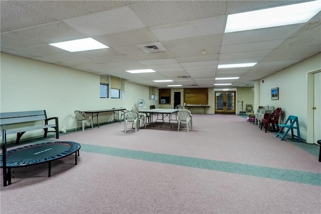 miscellaneous room with carpet floors and a drop ceiling