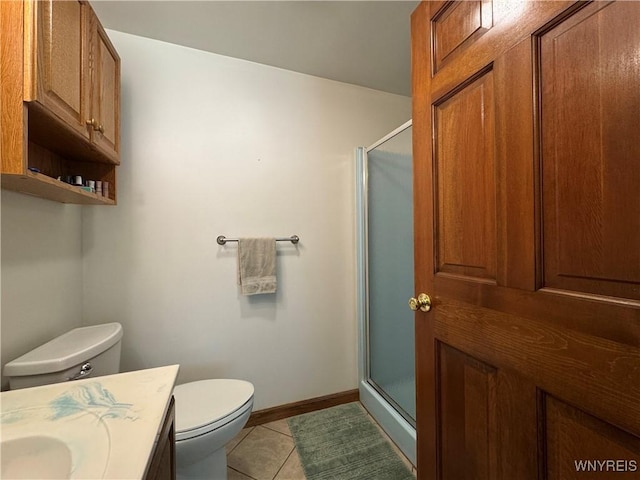 bathroom with a shower stall, tile patterned floors, toilet, and vanity