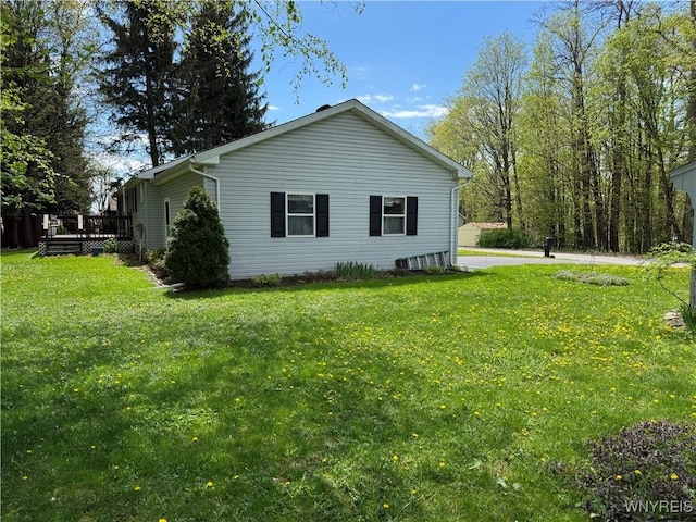 view of property exterior with a wooden deck and a lawn