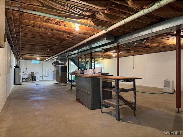 unfinished basement with gas water heater and heating unit