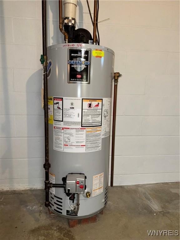 utility room with gas water heater