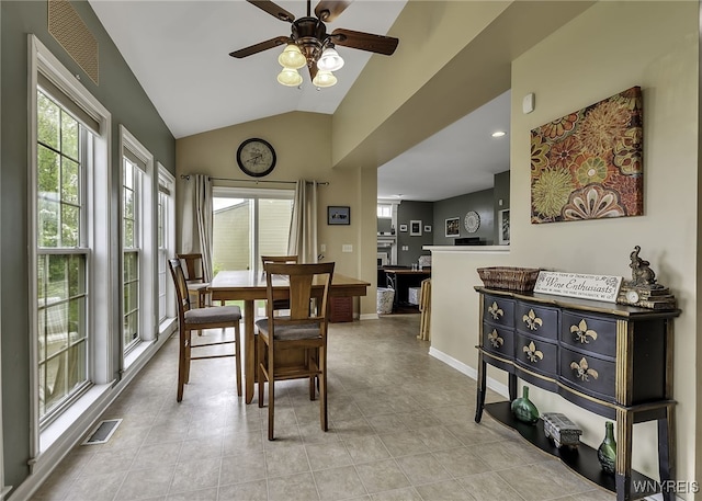 dining area with a ceiling fan, vaulted ceiling, and baseboards