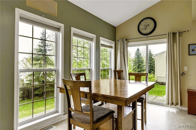 dining space with vaulted ceiling and plenty of natural light